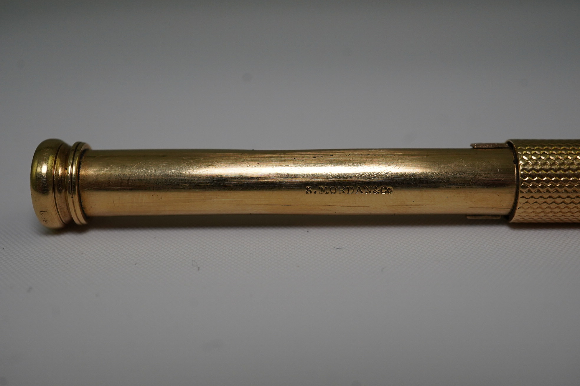 A late Victorian engine turned 18ct gold cased combination propelling pen and pencil, by Sampson Mordan & Co